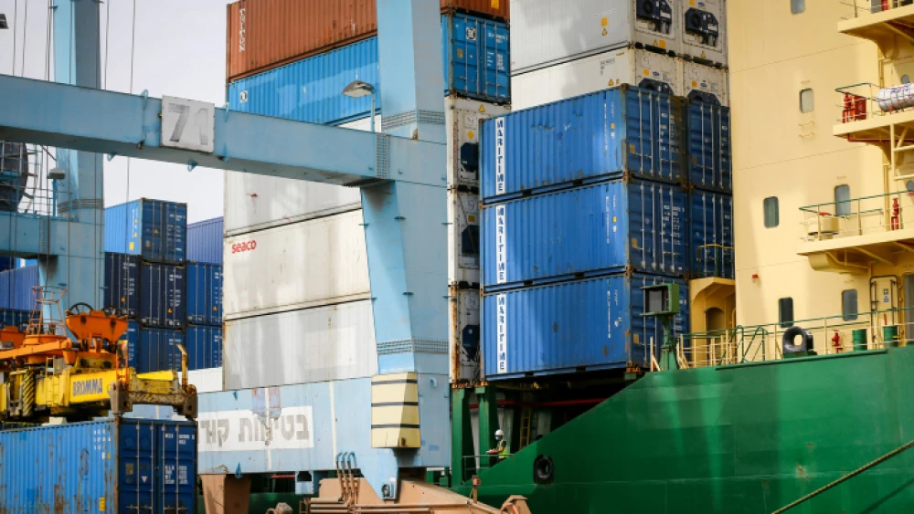 Workers unload shipping containers at Ashdod Port on Israel's southern coast on April 5, 2020. Photo by Flash90.