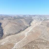 On Dec. 7, 2015, a representative of Regavim documented the completion of the preparations for paving. The images captured by drone photography clearly show that only a small section of the road passes through agricultural areas, while the vast majority of the road lies in arid, uninhabited areas, thus making it clear that the object of the Arab-oriented project is to seize territory in Area C and to annex the lands needed for a contiguous Palestinian state. Credit: Regavim.