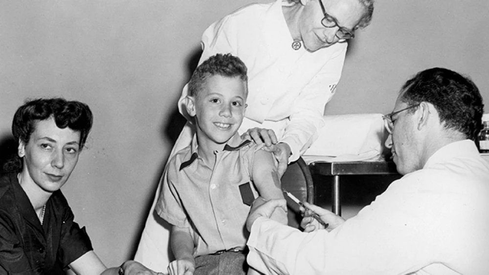 Peter Salk receives a polio vaccination from his father, Dr. Jonas Salk. Credit: March of Dimes.