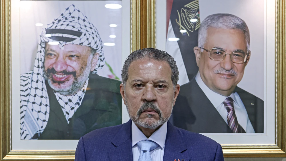 Palestinian-Canadian multimillionaire Yasser Abbas, newly elected member of Fatah's Central Committee, poses at his office in Ramallah, Samaria, in front of portraits of his father, Palestinian Authority and Fatah chief Mahmud Abbas, and Fatah founder Yasser Arafat on May 18, 2026. Photo by Jaafar Ashtiyeh/AFP via Getty Images.