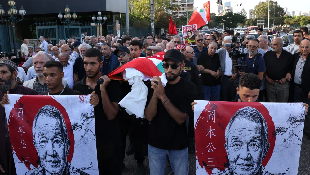 Members and supporters of the Popular Front for the Liberation of Palestine (PFLP), joined by Lebanese and Palestinian participants, carry the body wrapped in the Palestinian flag of Japanese terrorist Kozo Okamoto, also known as "Ahmed al-Yabani" (Ahmed the Japanese), during his funeral procession in Beirut on July 24, 2026. Photo by Anwar Amro / AFP via Getty Images.