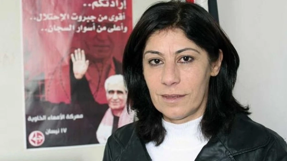 Addameer’s Khalida Jarrar In the background is a PFLP poster honoring imprisoned terrorist Ahmad Sa’adat, the ringleader of the squad that killed Israeli Minister Rehavam Zeevi in 2001.