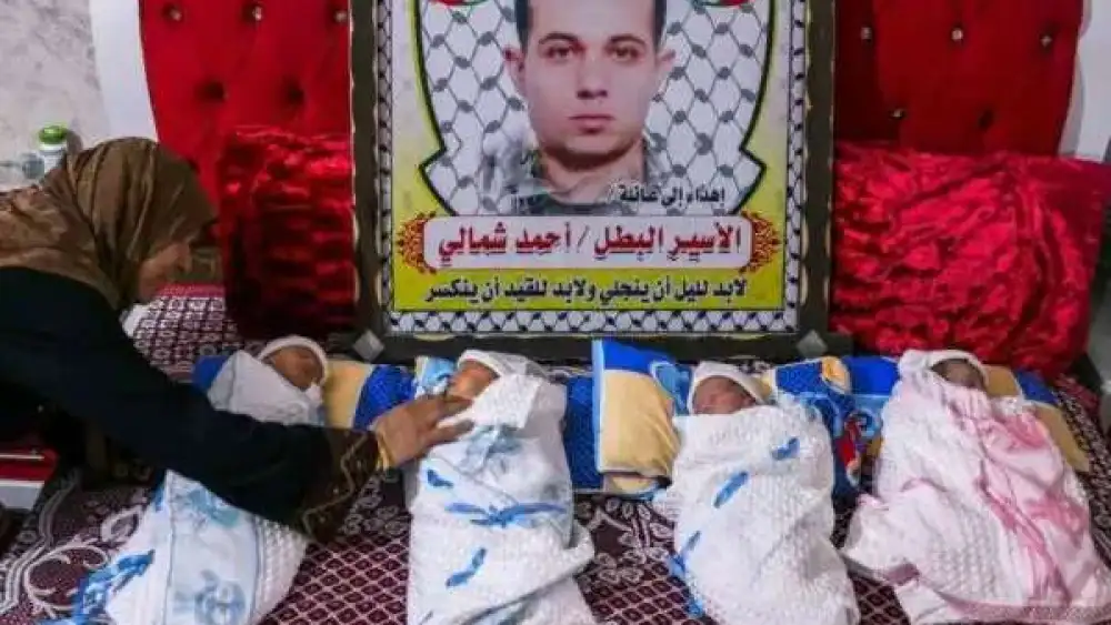 A picture of imprisoned terrorist Ahmad Shamali, together with his four children, conceived with sperm smuggled out of Israel's Nafha prison and into the Gaza Strip. Source: Social media via Israel Hayom.