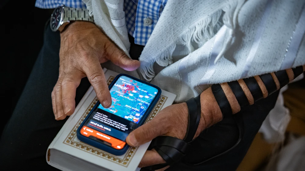People take cover at a public bomb shelter in Jerusalem as siren warns of incoming missiles fired from Iran, June 19, 2025. Photo by Noam Revkin Fenton/Flash90.