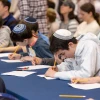 Students write feverishly at Chidon HaTanakh at Manhattan Day School. Photo by David Khabinsky.