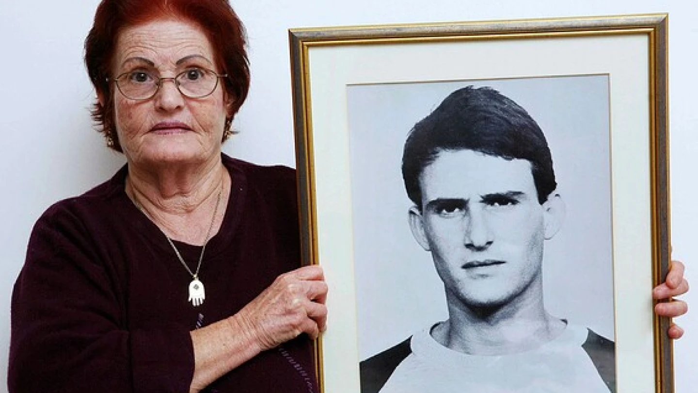 Galia Tamam holds a picture of her son, Moshe, who was murdered by Palestinian terrorists in 1984. Photo by Yehoshua Yosef.