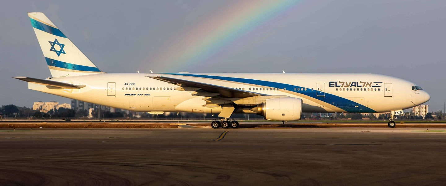 An El Al plane on the runway of Ben-Gurion International Airport with a rainbow in the background. Credit: Courtesy.