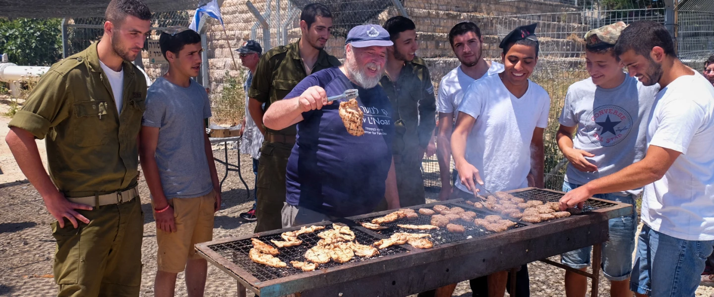 Israeli soldiers enjoy a barbecue prepared for them in honor of Israel's Independence Day in 2016 at the "soldiers corner," a place to rest and eat at the Gush Etzion junction. Credit: Gershon Elinson/Flash90.
