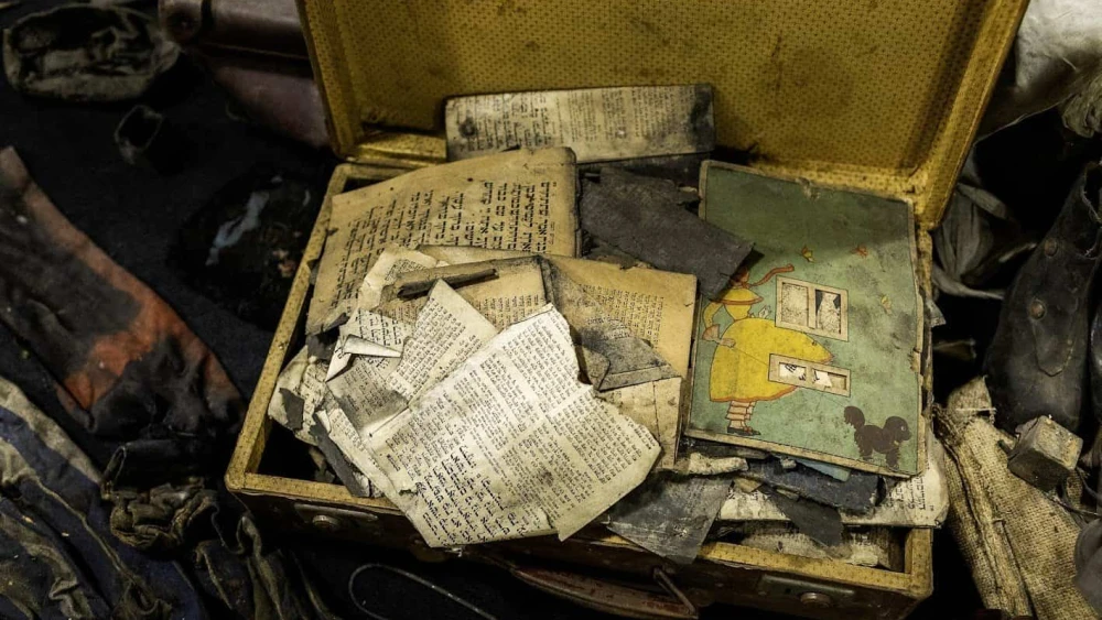 Jewish scripture lies inside one of the boxes storing a cache of items from Auschwitz donated in January 2025. Photo courtesy of Ambassador Yacov Livne/the Foundation of Memory Sites Near Auschwitz-Birkenau.