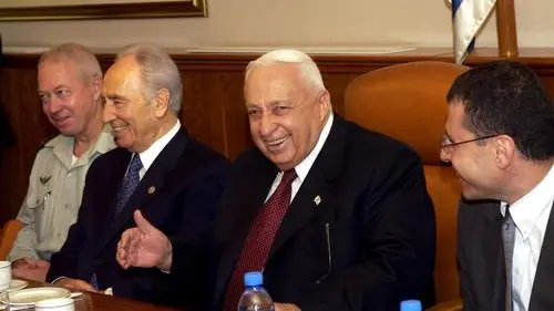 Click photo to download. Caption: Shimon Peres (second from left) and then-Prime Minister Ariel Sharon seen during the 80th birthday celebration for Peres in the Prime Minister's Office in Jerusalem on September 21, 2003. Crediit: Avi Ohayon/GPO/Flash90.