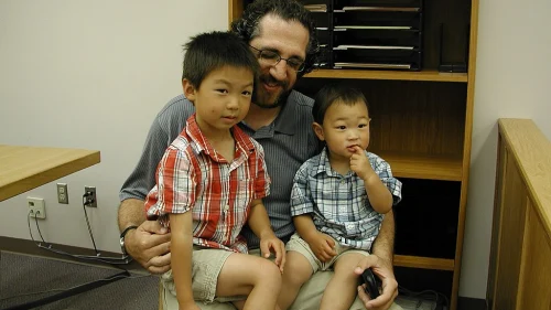 A father and his adopted sons. Photo by Brendon Connelly via Wikimedia Commons.