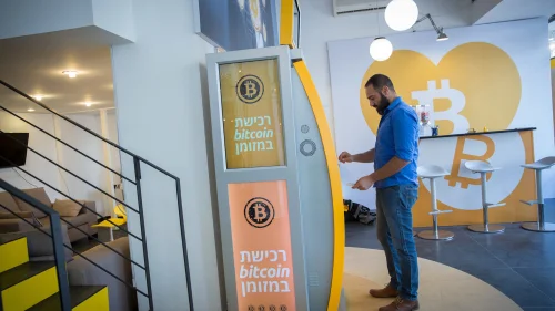 On Nov. 5, 2018, a man uses a bitcoin ATM machine at the Bitcoin Change center on Dizengoff Street in Tel Aviv. The center houses the ATM, as well as a museum on the history of the cryptocurrency. Credit: Miriam Alster/Flash90.