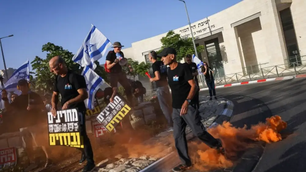 Activists protest against the government's planned judicial overhaul, outside Har Hamor Yeshiva in Har Homa, Jerusalem, on July 5, 2023. Photo by Chaim Goldberg/Flash90.