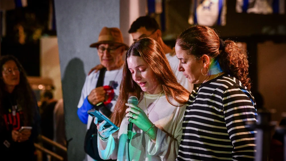 Chen Goldstein-Almog and her daughter Agam light Chanukah candles together with other members of Kibbutz Kfar Aza in Shefayim, Dec. 10, 2023. Photo by Avshalom Sassoni/Flash90.