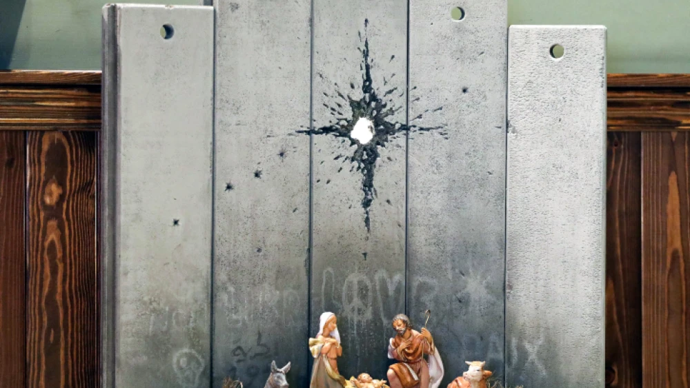 A view of a new artwork by British artist Banksy is displayed at the Walled Off hotel in the West Bank city of Bethlehem, on Dec. 22, 2019. Photo by Wisam Hashlamoun/Flash90.