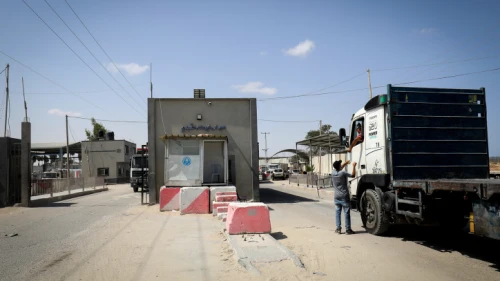 Palestinian trucks loaded with aggregate, iron and cement enter through the Kerem Shalom commercial crossing in the southern Gaza Strip, on Sept. 1, 2021. Photo by Abed Rahim Khatib/Flash90.