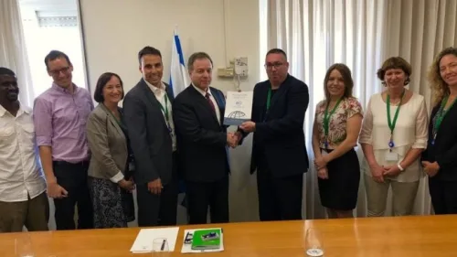 Director of the Society for International Development Israel Alon Beer, center right, presents the chief of staff of Israel's Prime Minister's Office, Yoav Horowitz, center left, with research on expanding Israel's international-development activity, May 15, 2019. Photo by Ariel Kahana/Israel Hayom.