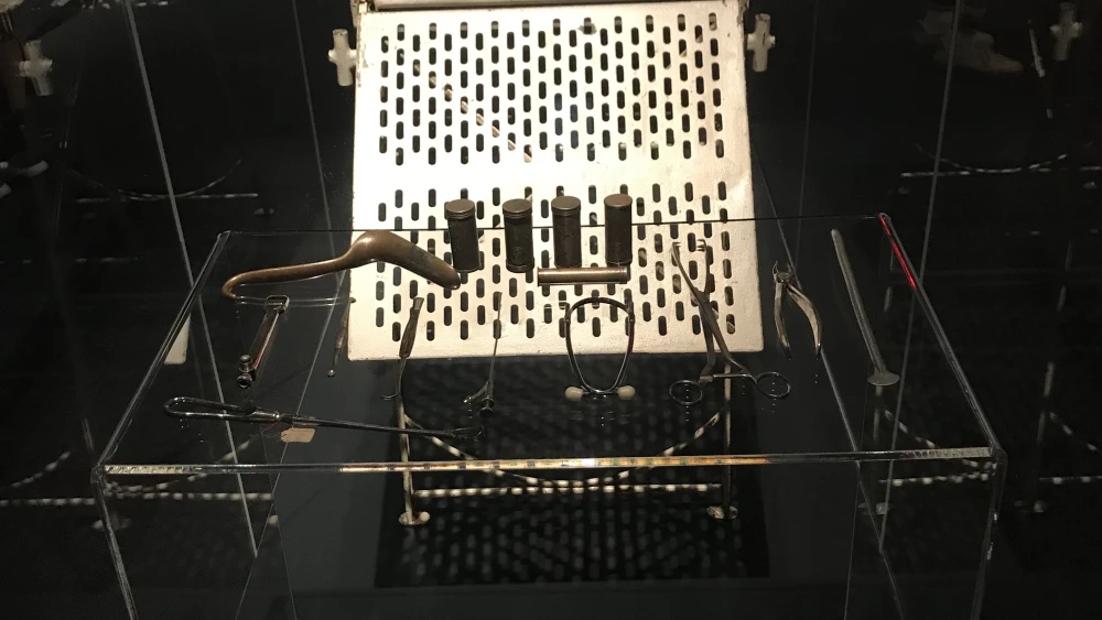 An operation table, test tubes and medical instruments from the Auschwitz concentration camp on display at “Auschwitz: Not long ago. Not far away.” The most notorious medical “researcher,” Dr. Josef Mengele often experimented on Auschwitz prisoners. Credit: Shiryn Ghermezian.