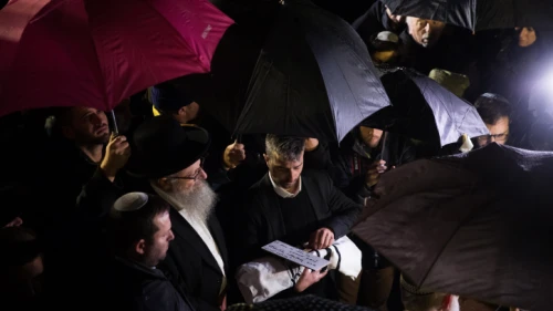 The 30-week-old son of Shira and Amichai Ish-Ran is cradled in a prayer shawl by his grandfather during his funeral at the Mount of Olives cemetery in Jerusalem on Dec. 12, 2018. Photo by Yonatan Sindel/Flash90.