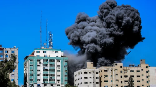 Smoke rising from the Al-Jalaa tower in Gaza City after an Israeli airstrike, which according to the Israel Defense Forces housed Hamas intelligence and weaponry. Several media outlets also had offices in the building, including the Associated Press and Al Jazeera. May 15, 2021. Photo by Atia Mohammed/Flash90.