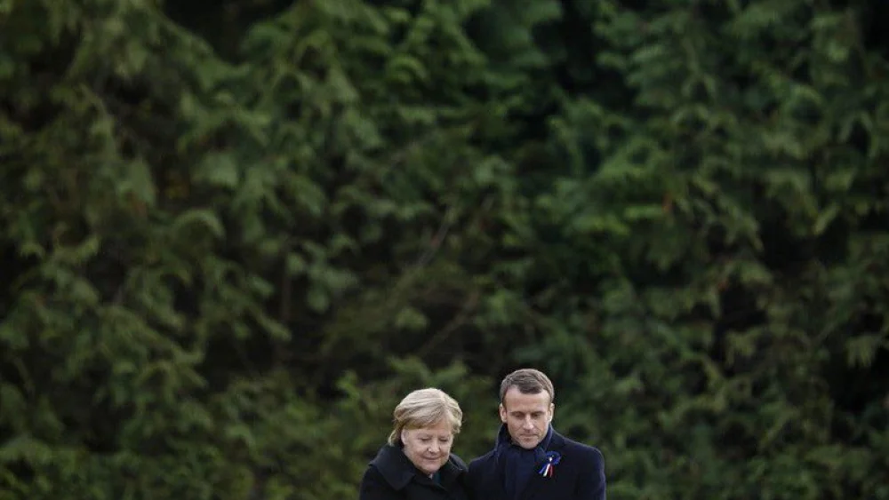 French President Emmanuel Macron and German Chancellor Angela Merkel embrace at a ceremony commemorating the centennial of the end of World War I. Credit: Emmanuel Macron via Twitter.