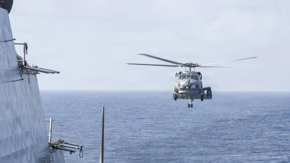 An MH-60R Sea Hawk helicopter approaches the USS Delbert D. Black (DDG 119) in the Arabian Sea, May 27, 2026. The helicopter was returning from patrol as part of the U.S. blockade against Iran. Source: @CENTCOM/X.