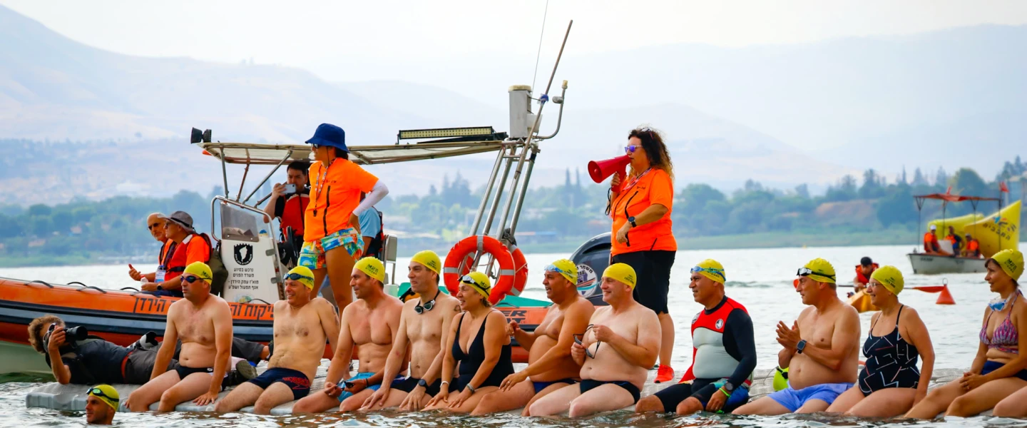 Swimmers participate in an open-water event in memory of Capt. Eden Nimri, a former Israeli national youth swimmer who was killed while defending fellow soldiers at the Nahal Oz IDF outpost during the Hamas massacre on Oct. 7, 2023, July 5, 2026. Credit: Maccabiah.