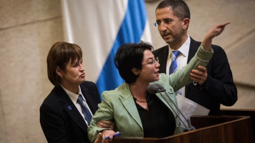 Knesset member Hanin Zoabi is removed by Knesset security during her speech at a plenum session before a vote on a bill requiring left-wing foundations and organizations to reveal their sources of funding, on Feb. 8, 2016. Photo by Hadas Parush/Flash90.