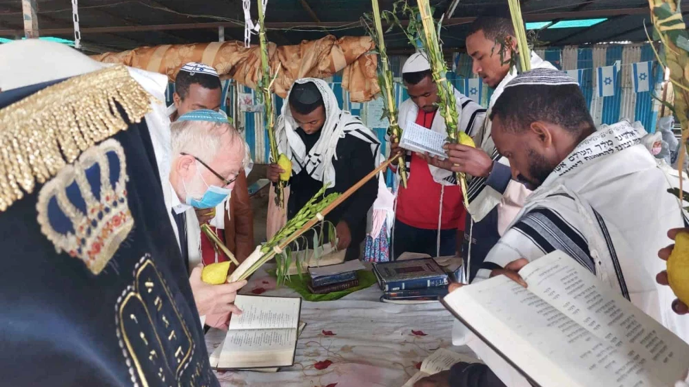Ethiopian Jews pray in the sukkah during the Jewish holiday of Sukkot. Credit: Courtesy of Struggle to Save Ethiopian Jews.