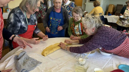 Author Yona Diamond Dansky teaches a group of students how to make knishes. Credit: Courtesy of Yona Diamond Dansky.
