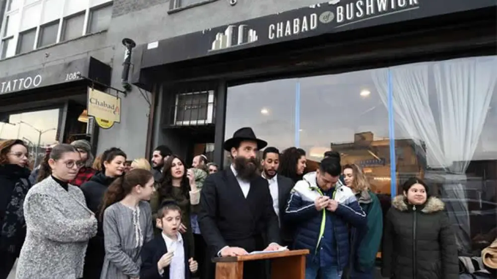 Rabbi Menachem Heller outside the Chabad House whose front window had been smashed on Feb. 15, 2019. Photo: Todd Maisel for Chabad.org/News.