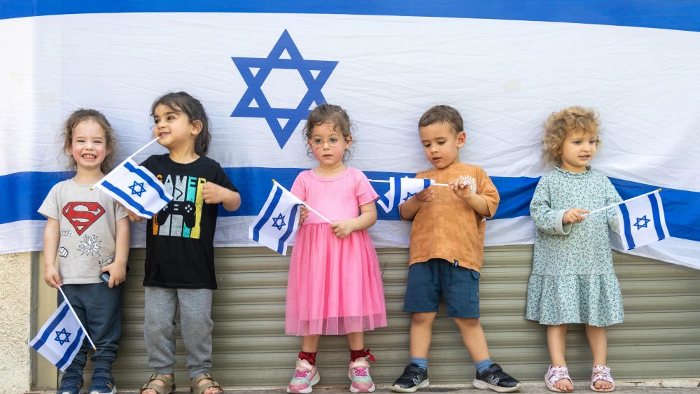 Israeli children play with Israeli flags ahead of Israel's 78th Independence Day