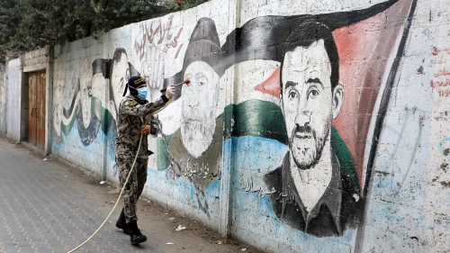 Members of the Palestinian Islamic Jihad's armed wing, the Al-Quds Brigades, spray disinfectant in the streets of Rafah in the southern Gaza Strip during a campaign aimed at slowing down the spread of the coronavirus, March 26, 2020. Photo by Abed Rahim Khatib/Flash90.