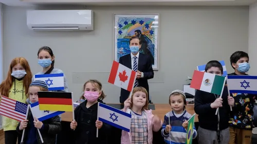 Then-Jewish Agency chairman Isaac Herzog with immigrant children, Dec. 27, 2020. Courtesy of David Salem.