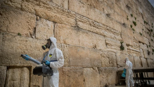 Israeli workers disinfect the Western Wall in the Old City of Jerusalem as a preventive measure against the spread of the COVID-19 virus, March 31, 2020. Photo by Yonatan Sindel/Flash90.
