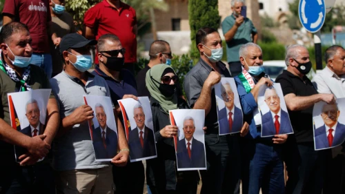Palestinians hold photo printouts during a rally in support of Palestinian Authority leader Mahmoud Abbas in the West Bank town of Tubas on Sept. 27, 2020. Photo by Nasser Ishtayeh/Flash90.
