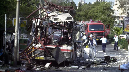 Police and rescue personnel work at the scene of a Palestinian suicide bombing on a bus in Haifa on March 5, 2003. Photo by Ronen Lidor/Flash90.