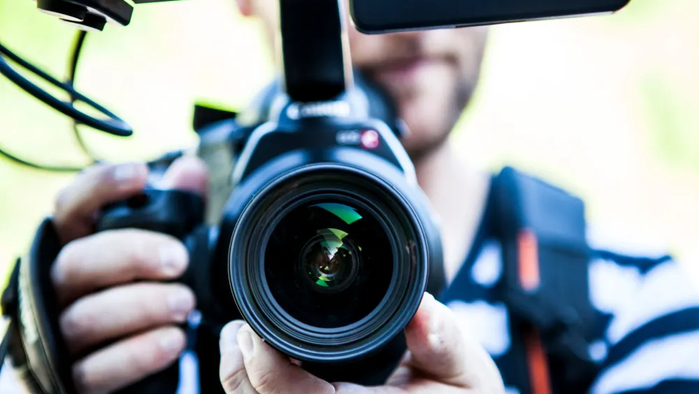 A man holding a camera. Credit: Terje Sollie/Pexels.