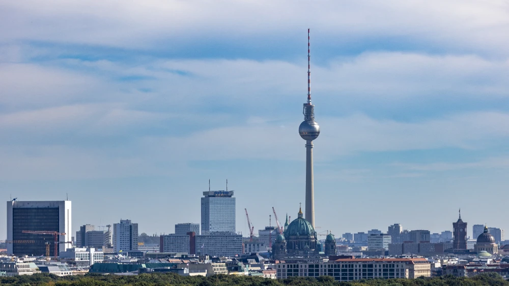 The landmark TV tower is seen on the skyline behind the canopy of trees in Tiergarten park in Berlin, Germany on Sept. 21, 2023. Photo by Odd ANDERSEN / AFP via Getty Images.