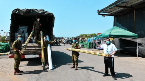 Israeli soldiers get materials to set up sukkahs for the holiday of Sukkot, October 2020. Credit: Courtesy of FIDF.
