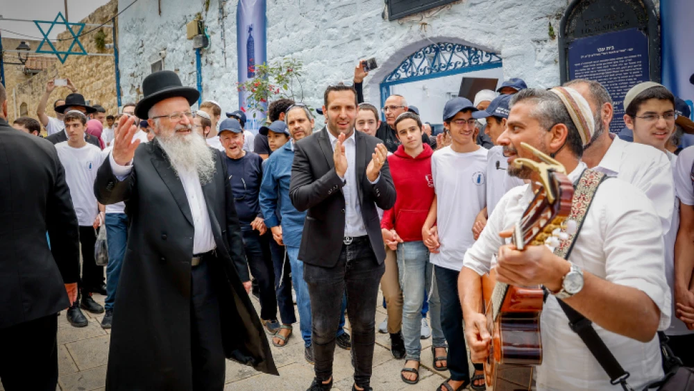 Tzfat's Mayor Shuki Ohana and Chief Rabbi Shmuel Eliyahu dance during the opening of the Lag B'Omer celebrations in the Galilee city, May 8, 2023. Photo by Gershon Elinson/Flash90.