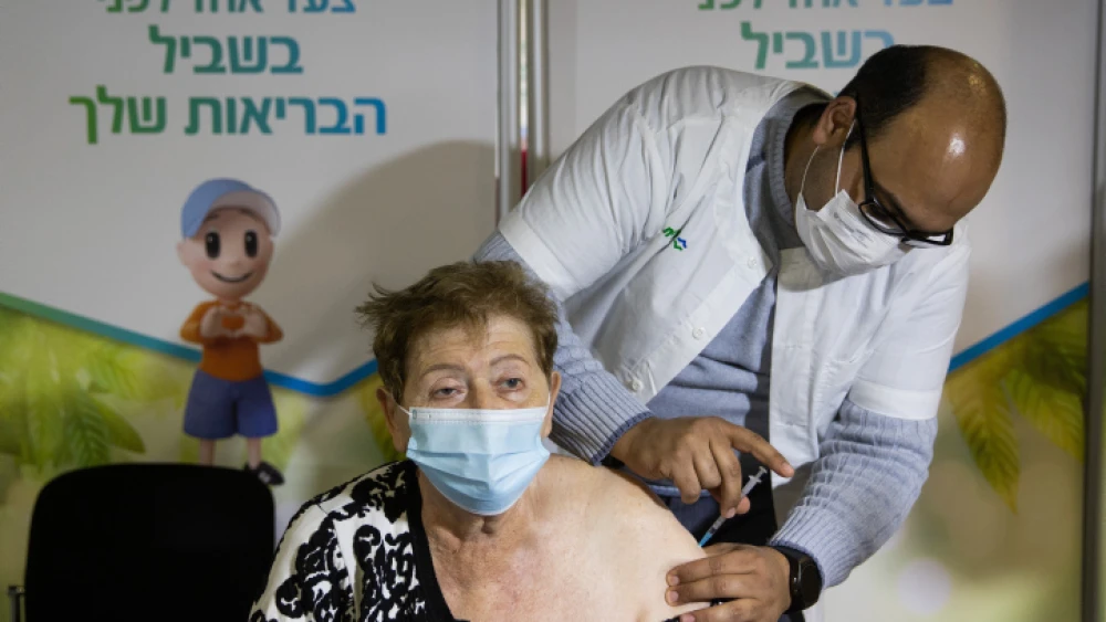Holocaust survivor Shimon Mira gets a COVID-19 vaccine at a vaccination center in Jerusalem on Jan. 6, 2021. Photo by Yonatan Sindel/Flash90.