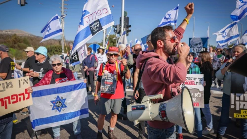 Residents and supporters of communities in northern Israel rally at the Amiad Junction in the Upper Galilee, calling for the government to better address their needs, Dec. 26, 2023. Photo by David Cohen/Flash90.