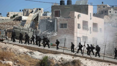 An Israeli military bulldozer demolishes a building in Sur Baher on July 22, 2019. Photo by Wisam Hashlamoun/Flash90.