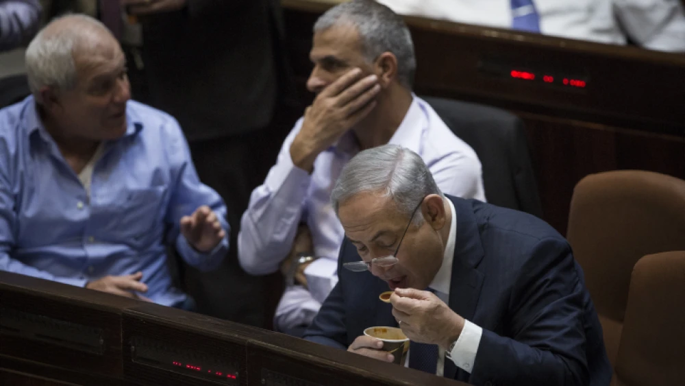 Israeli Prime Minister Benjamin Netanyahu seen eating soup during late-night votes at the assembly hall of the Israeli parliament on November 18, 2015, during the state budget vote for 2015-16. Photo by Hadas Parush/Flash90.