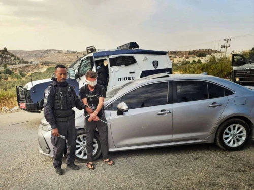 An Israeli police officer detains a Palestinian suspect in an undisclosed location in Judea and Samaria, as part of the law enforcement operation “Stopping at Red,” carried out in August, 2025. Credit: Israel Police.
