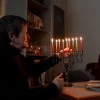 Galina Kovalenko, one of more than 40,000 Jews in Ukraine currently cared for by the American Jewish Joint Distribution Committee (JDC) as part of their Ukraine crisis response efforts, celebrates Hanukkah in her home in of Lviv, Ukraine. Credit: Yura Malenko.