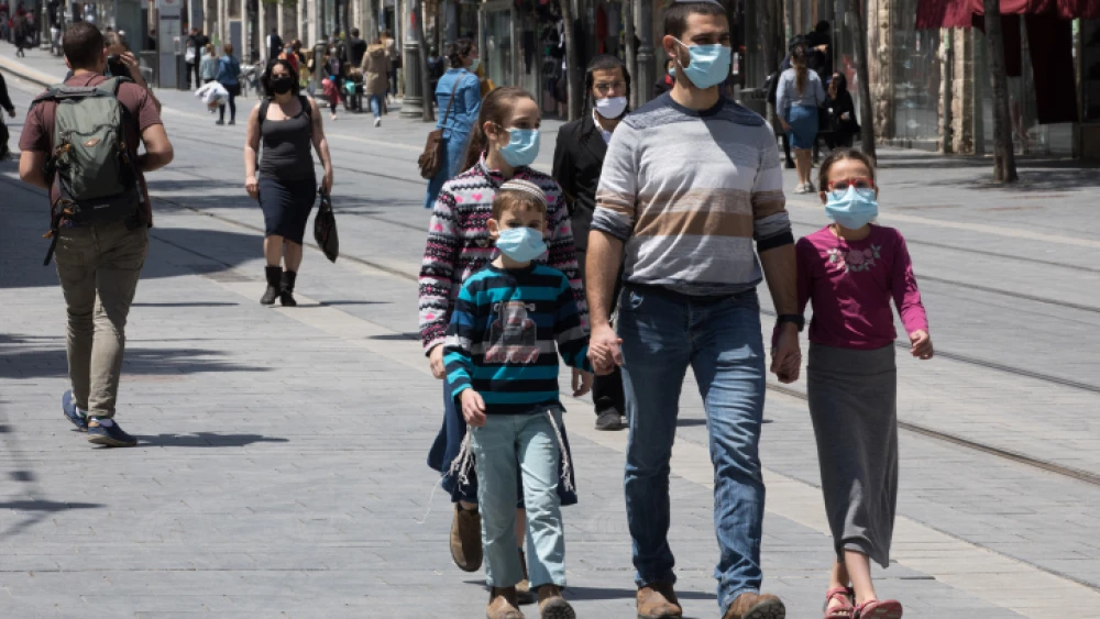 Israelis, face masks required, walk down Jaffa Street in downtown Jerusalem on April 26, 2020. Photo by Nati Shohat/Flash90.