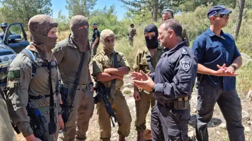 Israel Police Commissioner Yaakov Shabtai (second from right) talks with members of the Israeli forces participating in the search for the terrorists who murdered three people in the city of Elad on May 5, 2022, in this image posted on social media on May 8, 2022. Source: Israel Police Twitter.
