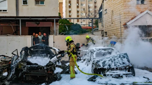 Rescue personnel at the site where a missile fired from Lebanon hit cars and caused damage in Kiryat Yam, northern Israel, on Nov. 7, 2024. Photo by David Cohen/Flash90.